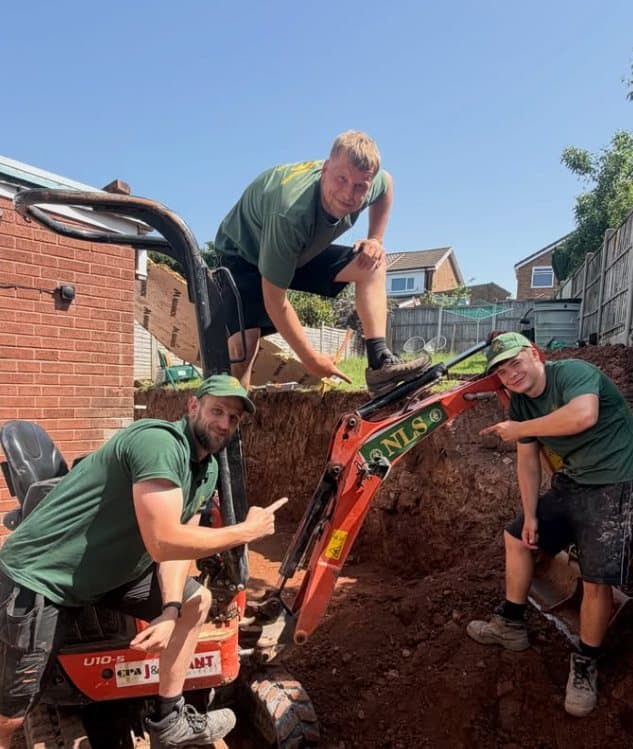 NLS team members working with a mini digger