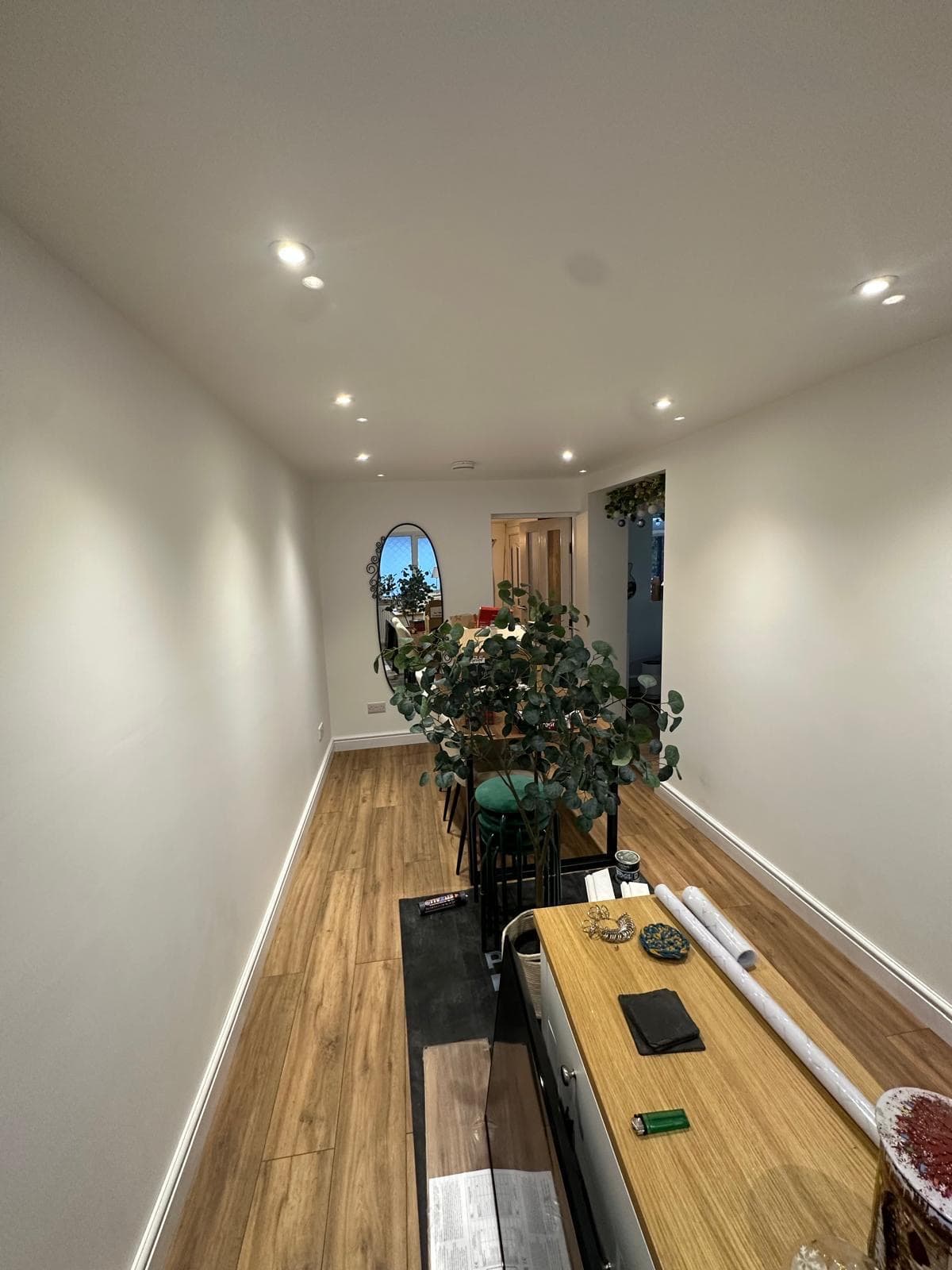 A converted garage finished as a dining room, looking back towards the opening through to the hallway